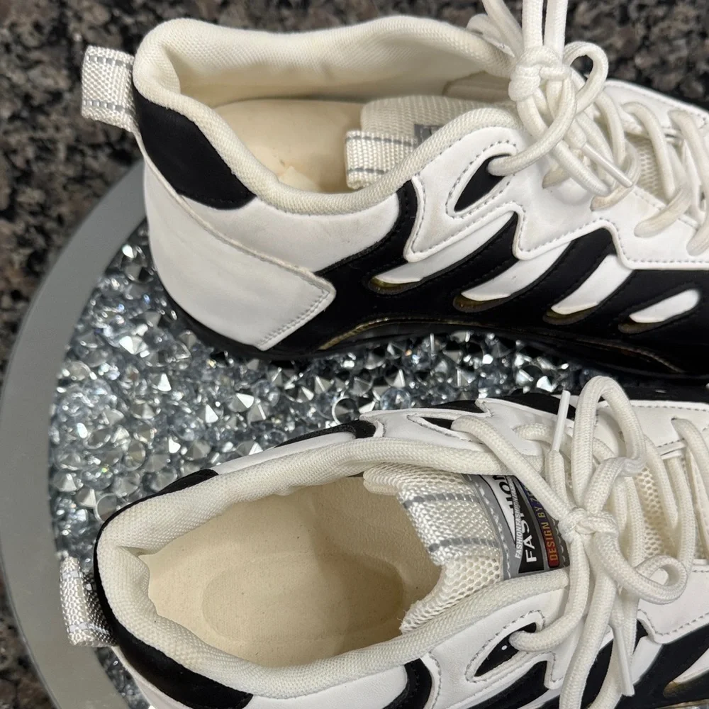 White and Black womens fashion Sneakers with gold accents EUC 10